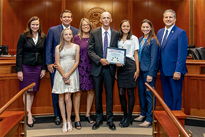 Leabo with Award and Patronis