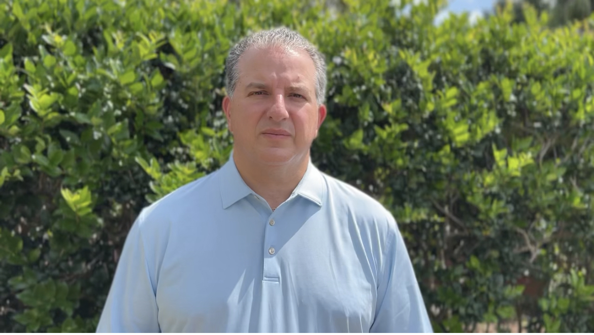 CFO Patronis standing in front of bush