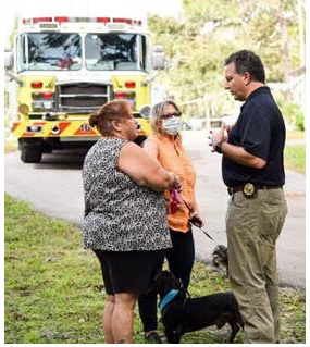 Patronis talking to women in front of fire truck