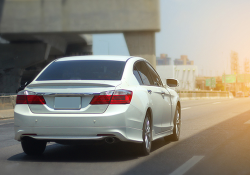 rear view of white sedan on highway