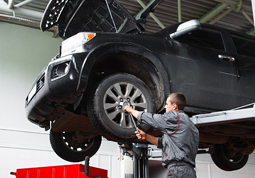 Magnuson-Thumbnail Mechanic under vehicle on lift