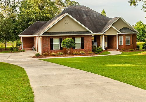 red brick single story residential property front façade