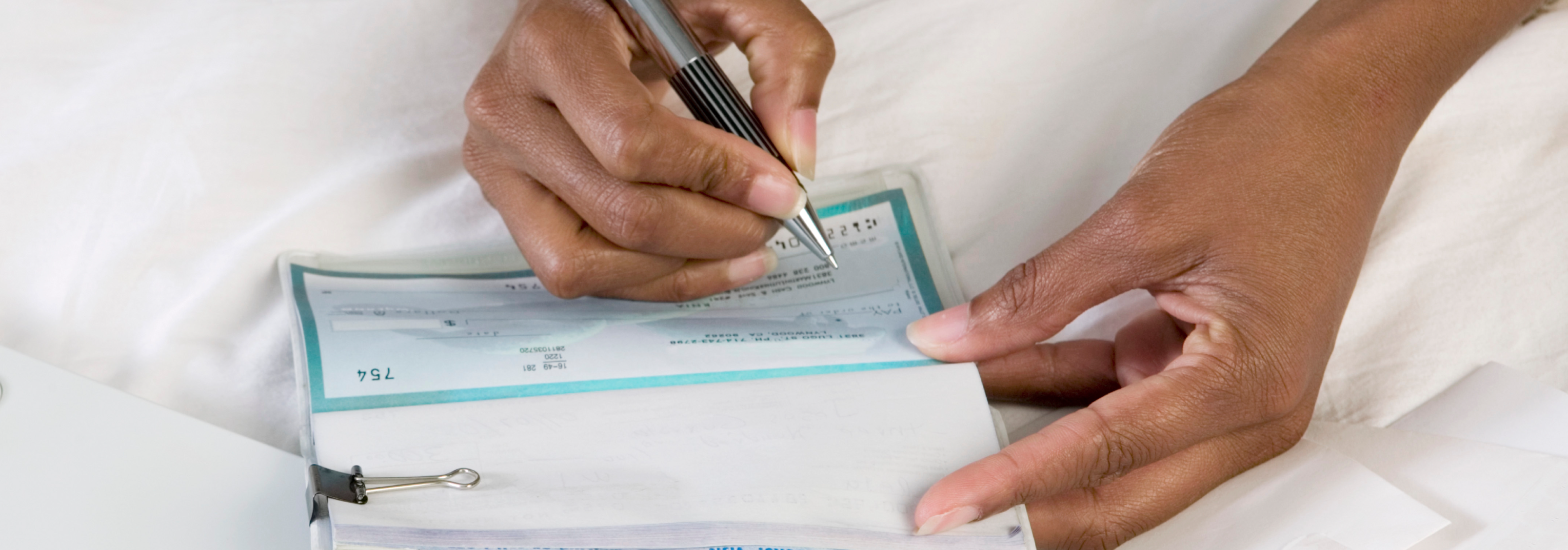 writing a check in a checkbook