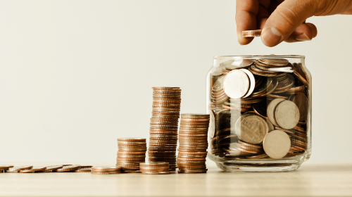 stack of coins next to a jar of coins - part of a whole