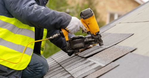 Roof Deductible Installing Shingles Roofer installing new shingles to roof