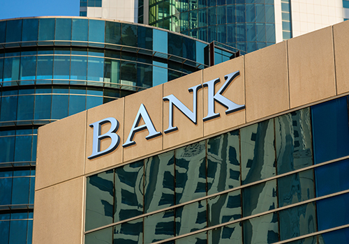 close up of bank building among other skyscrapers