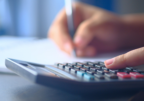 close up image of finger on calculator