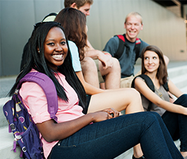 Black Teenager with classmates on steps at High School