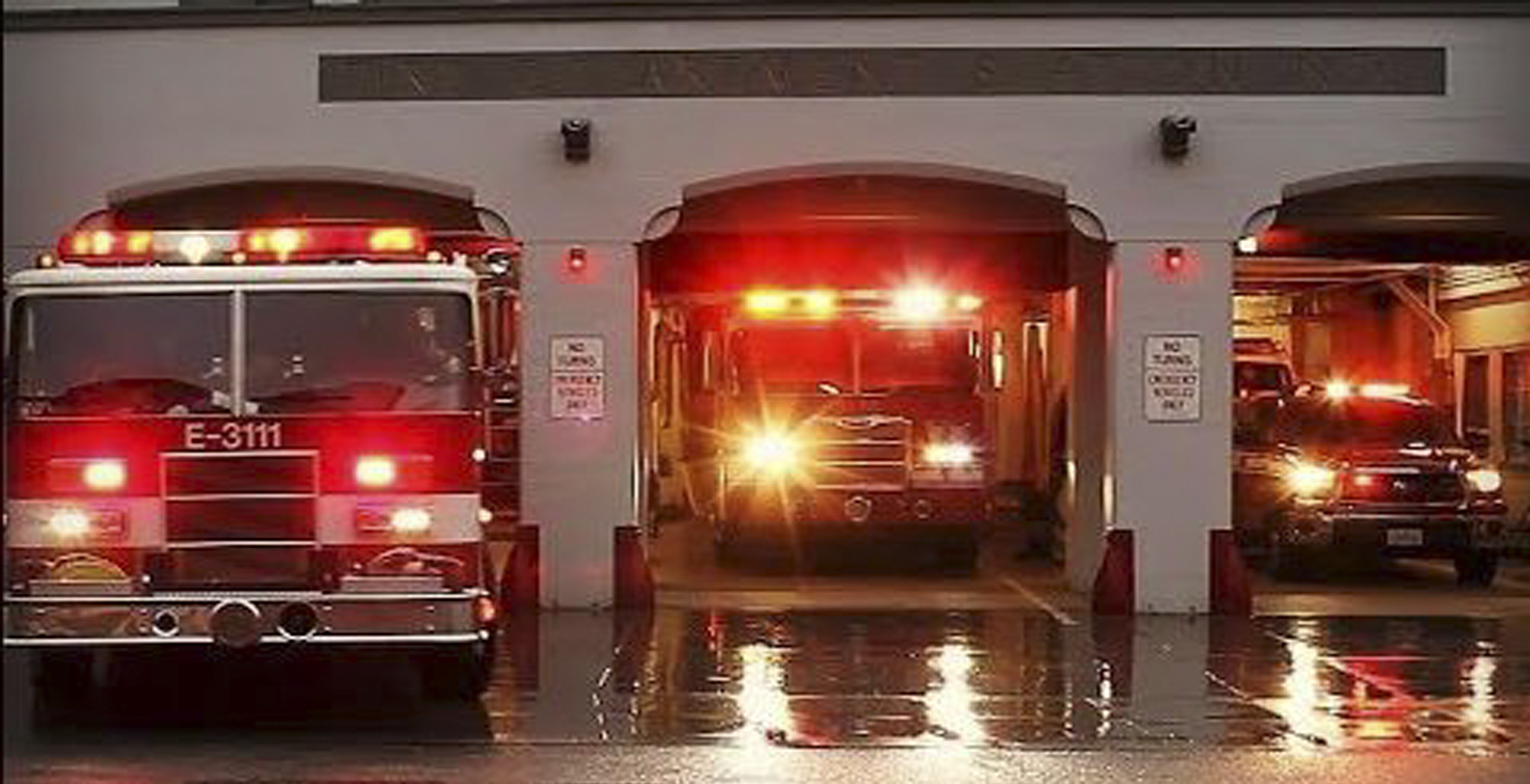 Fire Trucks with lights leaving the station
